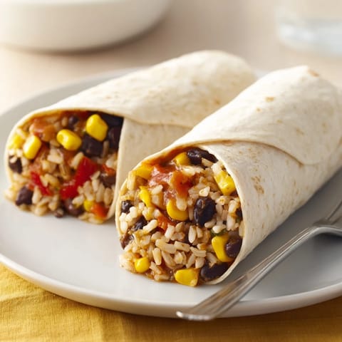 A close-up of a perfectly wrapped freezer-friendly burrito, showcasing the savory filling inside.