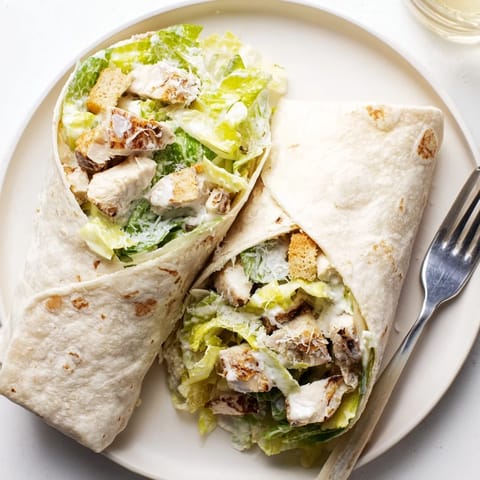 A close-up of delicious chicken Caesar wraps, showcasing the savory chicken and crunchy croutons inside.