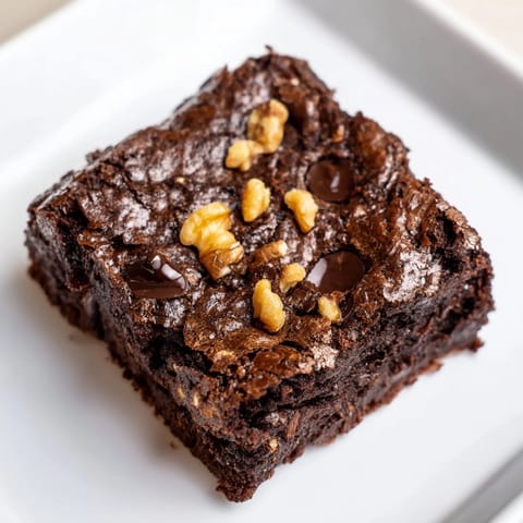 A square of decadent Greek yogurt brownies, rich with dark chocolate, perfect for dessert tonight.