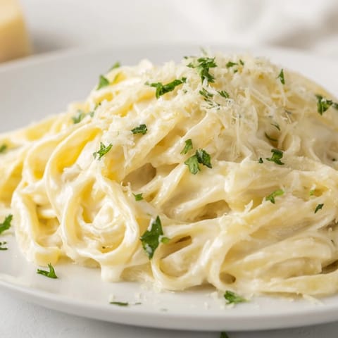 Smooth, blended Cottage Cheese Alfredo Sauce simmering in a pan, infused with garlic aroma.