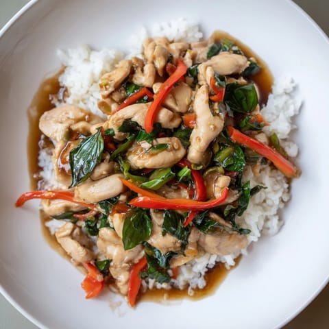 A close-up of savory Thai Basil Chicken Bowls, perfect for a quick and flavorful dinner tonight.