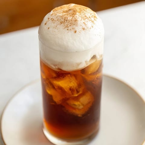 Picture the chilled Iced Chai Tea with Cold Foam, dusted with cinnamon, perfect for a sunny afternoon.