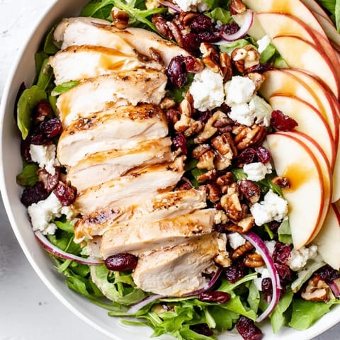 Vibrant image of Caramel Apple Chicken Salad, with mixed greens and a sweet and savory pecan dressing.