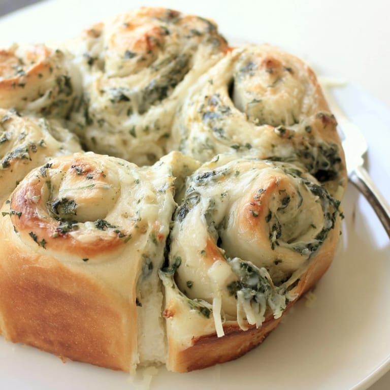 Fluffy, savory Spinach Alfredo Pull-Apart Rolls, a delicious appetizer fresh from baking.