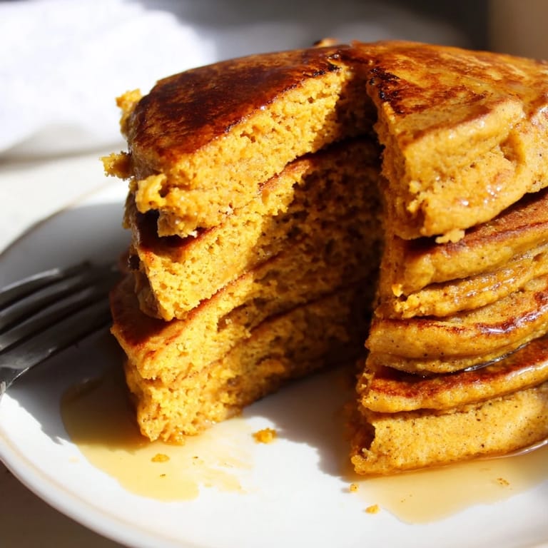 Delicious cinnamon sweet potato protein pancakes served warm for a nutritious breakfast.  