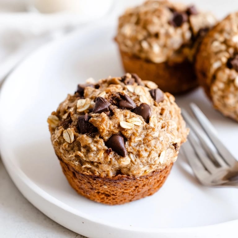 Hearty Peanut Butter Banana Oat Muffins topped with nuts, a delicious snack option.