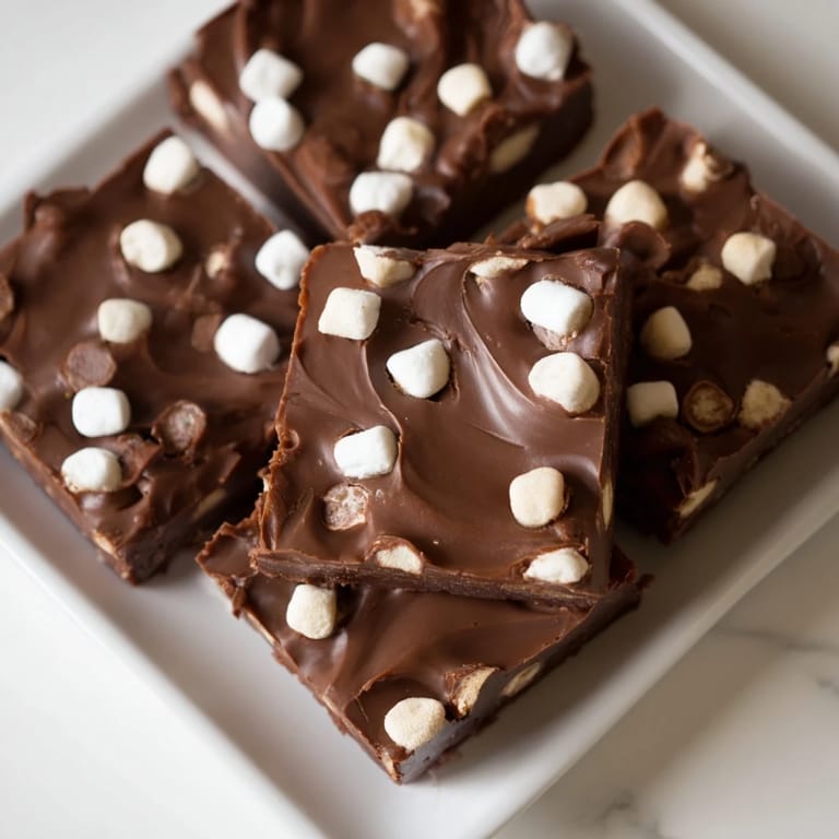 A close-up of freshly cut squares of Easy Marshmallow Fudge, offering a rich, chocolatey treat for dessert.