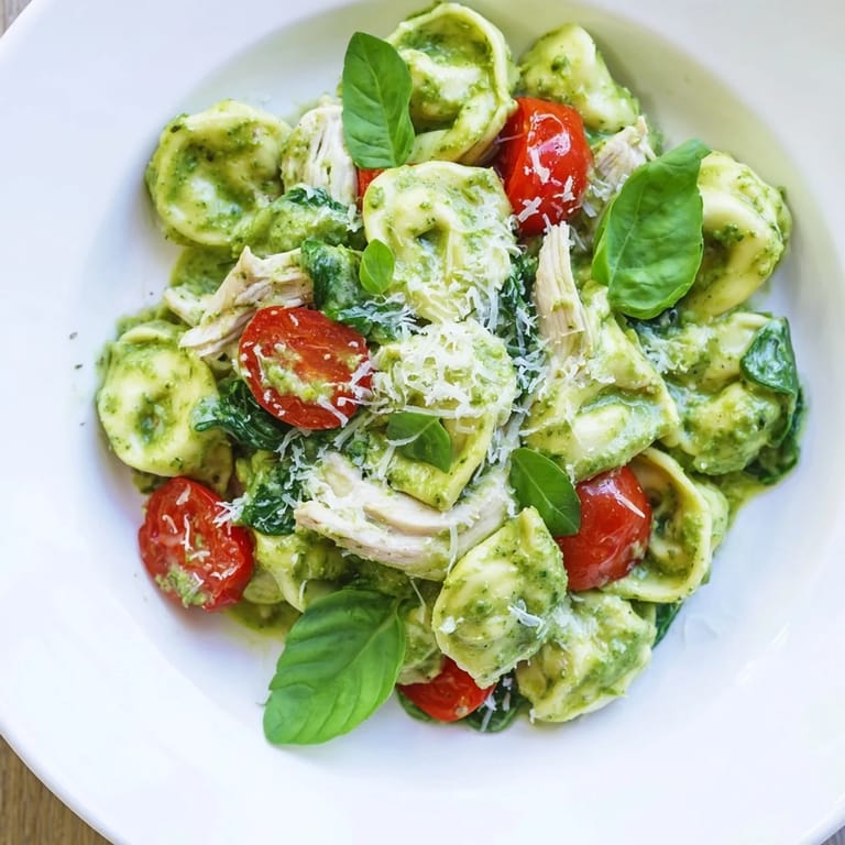 Delectable Creamy Pesto Tortellini Skillet with fresh spinach and vibrant cherry tomatoes, ready to serve.