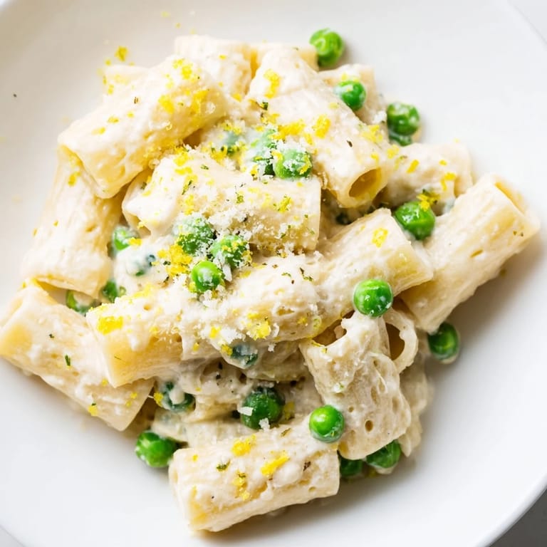 A satisfying bowl of fresh Pea & Lemon Ricotta Pasta, brightened with herbs and a sprinkle of Parmesan.