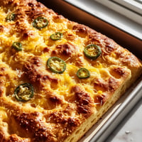 A baked dish with jalapenos on top.