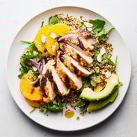 Citrus Herb Chicken Salad Bowl brimming with juicy, sliced chicken and bright orange segments, ready to be enjoyed.