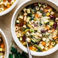 Hearty Minestrone Soup brimming with colorful seasonal vegetables and creamy cannellini beans in a rich tomato broth.